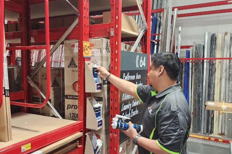 Worker replenishing a product