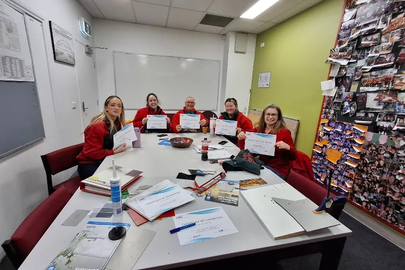 Workers holding certificates from training