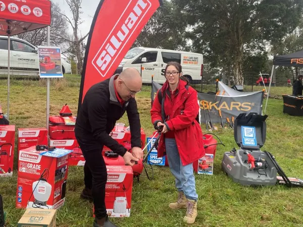 Man instructing a customer on using an outdoor appliance